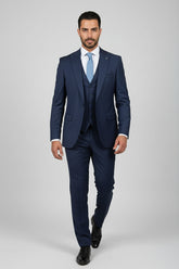 Man wearing tailored black suit with satin lapels, ideal for formal events.
